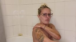 Amateur blonde MILF with glasses taking bath