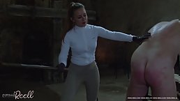 Young mistress in leggings whips her old slave