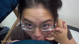 Young Asian girl with glasses deepthroats in the public dressing room