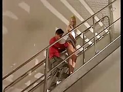 Horny blond is having sex with her younger lover on the stairs, and sucks his dick