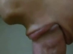 An exciting close- up of a girl who is sucking her lover's dick like a pro