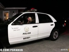 Slutty blond babe is dressed up as a police officer, while sucking two huge dicks