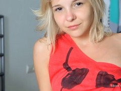 Pretty teen blonde with naughty fingers and a seductive smile fingers her shaved pussy