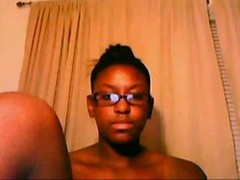 Lovely, black teen with glasses is fingering her perfectly shaved pussy in front of the web cam