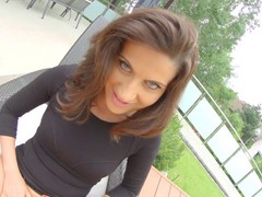 Blue- eyed brunette in black blouse inserst a glass dildo in her ass while kneeling on the floor