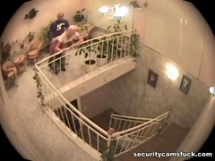 A security camera caught a horny couple while they were having sex near the stairs