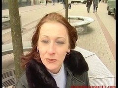 Passionate milf with red hair is giving a blowjob to her husband, in the living room
