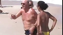 Oiled girls are not wearing their tops on the beach, because they like showing their tits