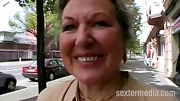 Lovely granny with a beautiful smile is sucking a younger dude's dick like a slut
