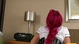 Slutty woman with red hair is sucking a huge, black dick while kneeling on the floor