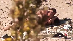 Horny couple is having steamy sex on a nudist beach and enjoying every second of it