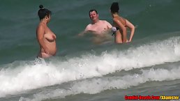 Hot, naked women are enjoying on the beach while guys are staring at their pussies