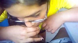Nerdy brunette with curly hair is sucking her lover's dick while he is trying to make a video