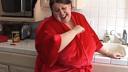 Fat woman is playing with her hairy pussy in the kitchen and enjoying it a lot
