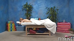 Hot babe is lying on the massage table, while a horny guy is rubbing her wet pussy