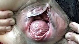 Mature woman with extra loose, hairy pussy is spreading her legs wide to show off