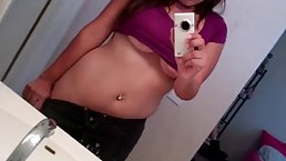 Lovely girl is making selfies while her shirt is lifted above her very nice tits