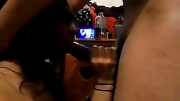Indian woman is gently sucking dick in front of the TV, in the living room