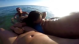 Adorable girl is sucking a stranger's dick on the beach, while another one is waiting for her turn