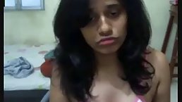 Dark haired, Indian girl is making her first web cam video, because she needs some money
