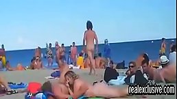 Horny voyeur is watching, while horny couples are having sex on the public nude beach