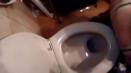 Naughty brunette is kneeling on the floor, in front of her partner and sucking his hard cock