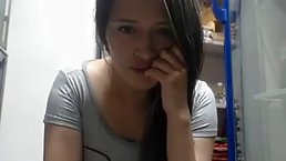 Dark haired babe is secretly masturbating in front of the camera, in the storage room