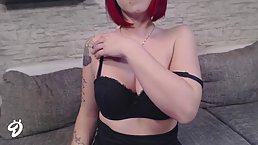 Red haired chick in black, latex pants is posing and teasing in front of the camera