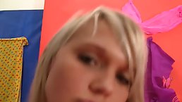 Pretty teen, Sandy is sitting on the armchair and sucking her horny guy’s fat cock