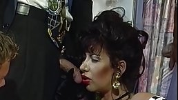 Dark haired woman with big milk jugs is doing it with many guys at the same time