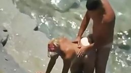 Nude woman does not even care if someone might be staring at her at the beach
