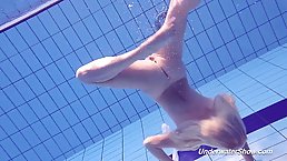 Lovely blonde babe took off all of her clothes and jumped into the swimming pool