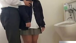 Japanese brunette is kneeling in the toilet and sucking a rock hard dick like a pro