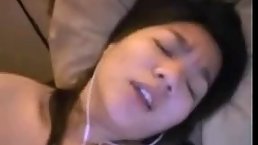 Asian babe is moaning from pleasure while rubbing her pussy during the phone call with her boyfriend