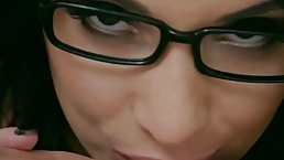 Brunette with glasses, Anissa Kate is sucking a rock hard dick and rubbing it with tits