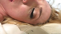 Blue- eyed blonde, Dahlia Sky is kneeling on the floor and sucking her lover's cock