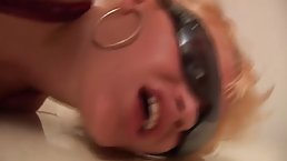 Mature blonde woman with big tits is holding her legs lifted high while getting fucked hard