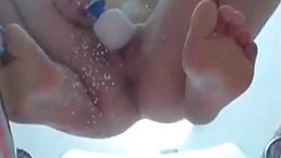 Nude babe is using a vibrator to satisfy her needs and peeing while experiencing an orgasm
