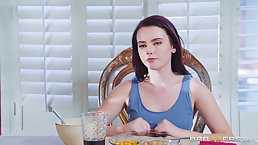 Red haired babe, Karli Brookes is rubbing her lover's dick from under the table, with her feet