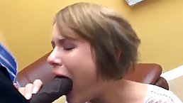 Young babe is kneeling in front of her lover and sucking his big black cock
