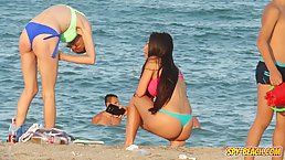 Adorable girls are having a great time on the beach while guys are checking out their asses