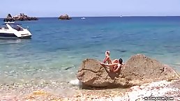 Lustful Mia Magma is gently sucking her friend's rock hard dick on a beautiful beach