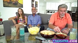 Pretty teen in a floral shirt is holding her legs lifted high while getting fucked hard