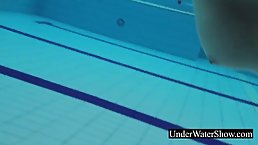 Naughty, red haired babe was swimming in a sheer dress, just for the fun of it