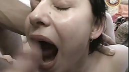Chubby brunette is kneeling in front of many guys and giving them blowjobs like a whore