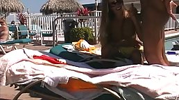 Dirty minded babe is rubbing dick on the beach and getting fucked from the back