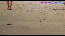 Attractive naked couple is walking down the beach, while a horny voyeur is taking hot photos
