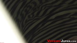 Lovely Asian brunette is playing with her big tits and pussy and enjoying it a lot