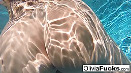 Wealthy blonde woman, Olivia Austin is rubbing her perfectly shaved pussy in the swimming pool
