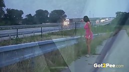 Naked babe with nice tits is pissing outside, while a horny voyeur is recording a video